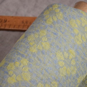 Pure linen fabric Flora Breezy. Floral geometric jacquard pattern woven from pastel yellow and pastel blue colors. Pattern repeats at each 6cm. The oposite sides of the fabric are different but both sides can be used as a right side.