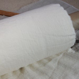 Pure linen fabric. It has a very slight tint of creamy/yellowish/grayish and even a pinkish at the same time, very pale, milky, smooth and buttery. The fabric is middle weight, strong and durable, densely and plain woven, not sheer.