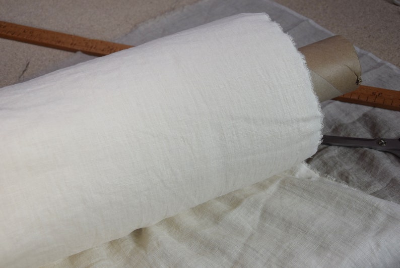 Pure linen fabric. It has a very slight tint of creamy/yellowish/grayish and even a pinkish at the same time, very pale, milky, smooth and buttery. The fabric is middle weight, strong and durable, densely and plain woven, not sheer.