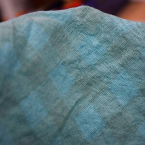 K&ouml;nnte beinhalten: Nahaufnahme eines weichen, blauen Stoffes mit einem dezenten, gefleckten Muster. Der Stoff hat eine leicht strukturierte Oberfl&auml;che und ein entspanntes, l&auml;ssiges Gef&uuml;hl.