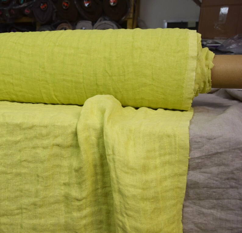 May include: A roll of bright yellow linen fabric. The fabric is soft and has a natural texture. It is ideal for sewing projects, home decor, and more.