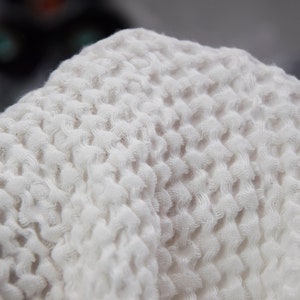 The fabric is very soft and fluffy, surface of the fabric has a texture that looks like a waffle.