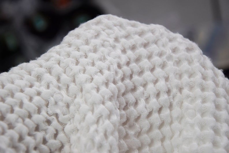 The fabric is very soft and fluffy, surface of the fabric has a texture that looks like a waffle.