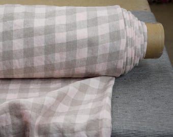 May include: A roll of pink and gray gingham fabric. The fabric is woven with a checkered pattern.