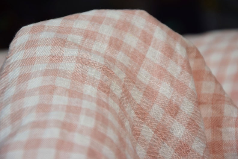 Pure linen fabric Aurora Blush Pink Gingham. The fabric is dense, not sheer, naturally wrinkled. Clolors of the gingham are white and pale pink. Cells are 8mm. The fabric is aesthetic, strong, durable, organic, pleasant to touch, pre-shrunk.
