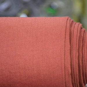 Pure linen fabric Gloria Red River Clay from LINENGRAPHY. This glamorous, deep, rare and original shade of red holds together brownish and purplish tones. Rich but not too bright. Middle weight, dense, not sheer, plain.