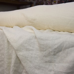 Pure linen fabric. It has a very slight tint of creamy/yellowish/grayish and even a pinkish at the same time, very pale, milky, smooth and buttery. The fabric is middle weight, strong and durable, densely and plain woven, not sheer.