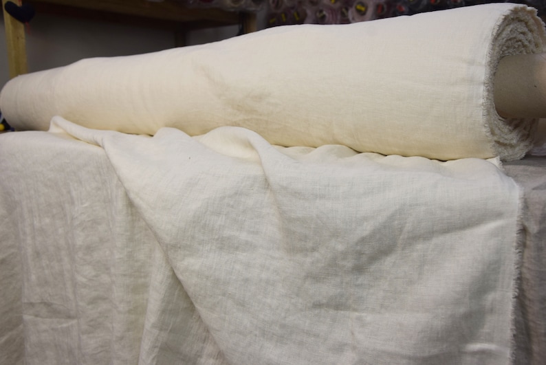 Pure linen fabric. It has a very slight tint of creamy/yellowish/grayish and even a pinkish at the same time, very pale, milky, smooth and buttery. The fabric is middle weight, strong and durable, densely and plain woven, not sheer.