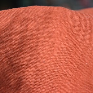 Pure linen fabric Udana Rust blends into any modern interior. 
The Rust color is saturated burnt brown-orange. Quite bright and highlighted, resembling iron oxide.