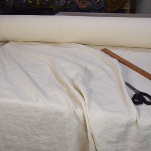 Pure linen fabric. It has a very slight tint of creamy/yellowish/grayish and even a pinkish at the same time, very pale, milky, smooth and buttery. The fabric is middle weight, strong and durable, densely and plain woven, not sheer.