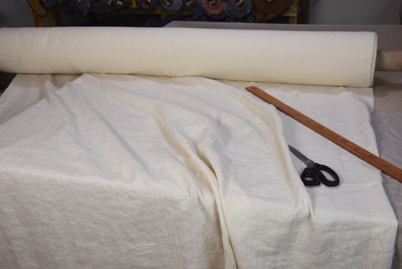 Pure linen fabric. It has a very slight tint of creamy/yellowish/grayish and even a pinkish at the same time, very pale, milky, smooth and buttery. The fabric is middle weight, strong and durable, densely and plain woven, not sheer.
