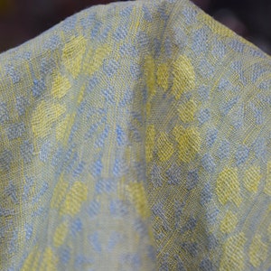 Pure linen fabric Flora Breezy. Floral geometric jacquard pattern woven from pastel yellow and pastel blue colors. Pattern repeats at each 6cm. The oposite sides of the fabric are different but both sides can be used as a right side.