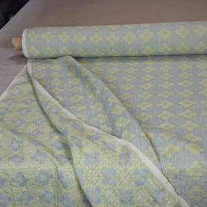 Pure linen fabric Flora Breezy. Floral geometric jacquard pattern woven from pastel yellow and pastel blue colors. Pattern repeats at each 6cm. The oposite sides of the fabric are different but both sides can be used as a right side.