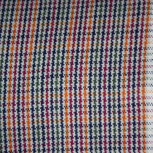 Linen/cotton fabric Mabela Multicolor Tweed. Quite heavy weight striped twill. Very small woven houndstooth pattern, color mix: beige, green, orange, burgundy, navy. Aesthetic, strong and durable, organic, antistatic, breathing, pleasant to touch.