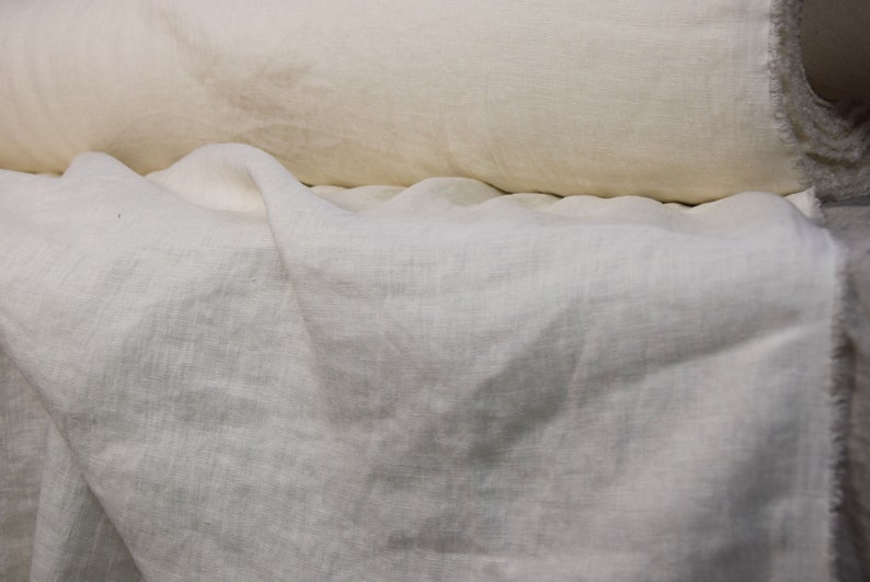 Pure linen fabric. It has a very slight tint of creamy/yellowish/grayish and even a pinkish at the same time, very pale, milky, smooth and buttery. The fabric is middle weight, strong and durable, densely and plain woven, not sheer.