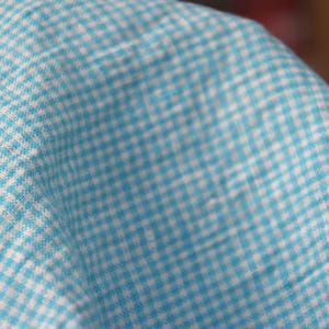 Pure linen fabric Terra Turquoise Gingham. Small mini 2mm vichy (gingham) checks. Quite bright, saturated  turquoise blue. Middle weight. Densely woven, not sheer.