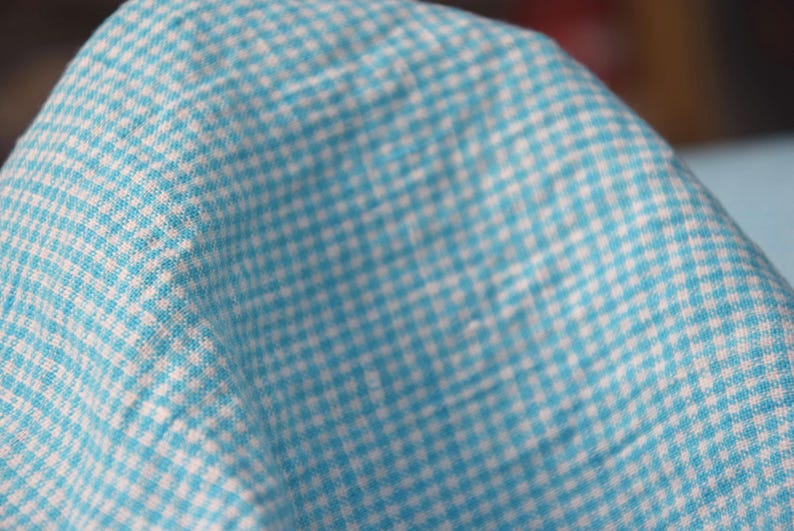Pure linen fabric Terra Turquoise Gingham. Small mini 2mm vichy (gingham) checks. Quite bright, saturated  turquoise blue. Middle weight. Densely woven, not sheer.