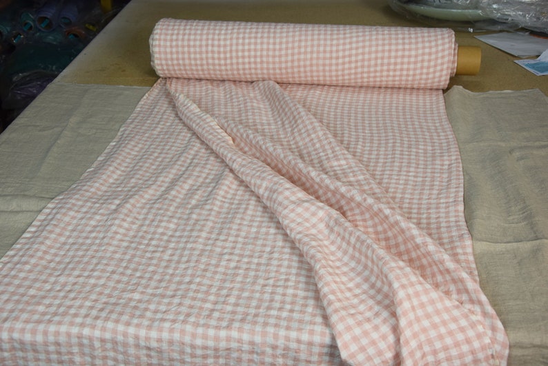 Pure linen fabric Aurora Blush Pink Gingham. The fabric is dense, not sheer, naturally wrinkled. Clolors of the gingham are white and pale pink. Cells are 8mm. The fabric is aesthetic, strong, durable, organic, pleasant to touch, pre-shrunk.
