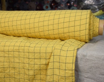 IN STOCK. 100% linen fabric Margarita Yellow Graph Check 195gsm (5.70oz/yd2). Dark blue grid pattern on yellow background. Washed-softened.