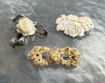 3 vintage celluloid and MOP white rose brooches