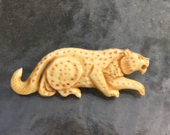 Vintage hand carved bone leopard brooch