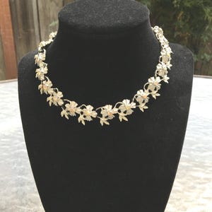 Engraved silver flower detailing with rhinestone accents on the 8.75