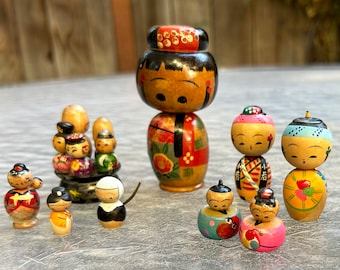 15 vintage wooden Japanese Kokechi bobblehead dolls from the 1950s