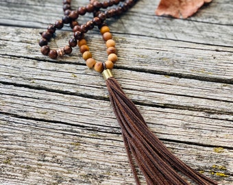 Wood bead mala with soft leather tassel.