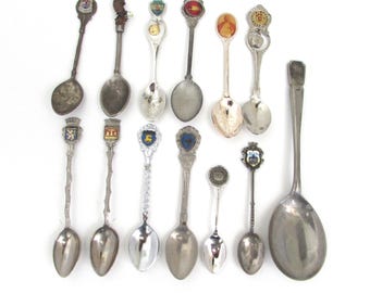 A Dozen Plus 1 Souvenir Spoons from many countries, states