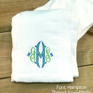 May include: White towel with a green and blue embroidered monogram "GMS". The text "Font: Hampton Thread: Kiwi+Marlin" is below the monogram.