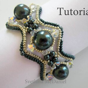 May include: A beaded bracelet with a dark green and gold color scheme. The bracelet features a geometric design with multiple rows of beads and three large, dark green pearls. The text "Tutorial" is visible in the upper right corner of the image.
