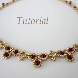 May include: A gold and burgundy beaded necklace with a delicate, intricate design. The necklace features small, round beads arranged in a pattern of repeating squares and circles.