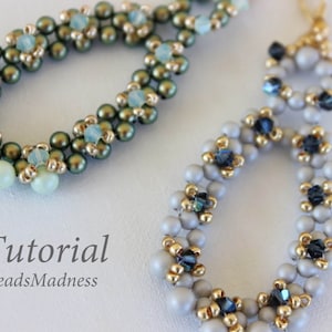 May include: A pair of beaded earrings with a floral design. The earrings are made with green, blue, and silver beads. The earrings are hanging from gold ear wires. The text "Tutorial BeadsMadness" is visible below the earrings.