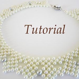 May include: A white pearl necklace with a silver clasp. The necklace is made of small, round pearls that are strung together in a delicate pattern. The necklace is a beautiful and elegant piece of jewelry that would be perfect for any occasion.
