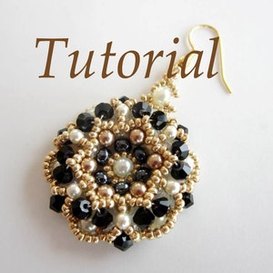May include: A gold, black, and white beaded earring with a dangling hook. The earring is made with small round beads and has a floral design.