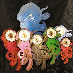 May include: Five wooden octopus clocks in different colors, including blue, green, red, pink, and brown. Each clock has a gold-colored face with black hands and Roman numerals.