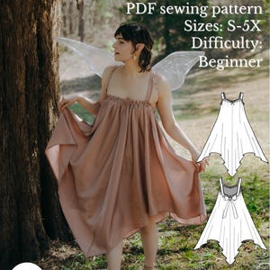 May include: A woman wearing a dusty rose-colored dress with a flowing skirt and delicate straps, posing outdoors with fairy wings. The image includes the text "Flutter Fairy Dress" and details about the PDF sewing pattern, sizes S-5X, and difficulty level: Beginner.