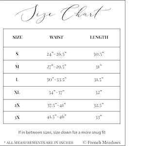 May include: A size chart with the title "Size Chart" in elegant script. The chart lists sizes S to 3X, with corresponding waist and length measurements in inches. Includes a note about sizing down for a snug fit and the brand name.