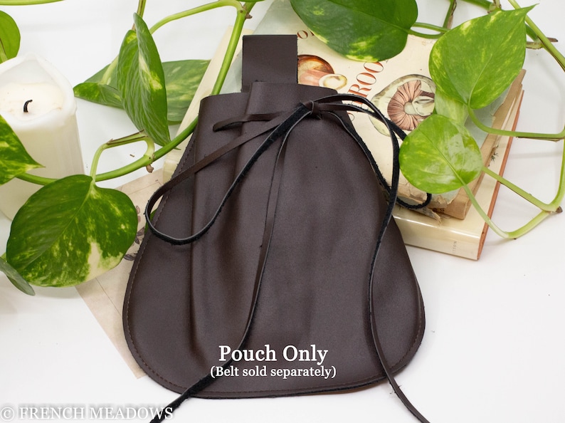 A brown leather pouch with a drawstring closure. The pouch is tied with a black ribbon and has a brown leather strap.