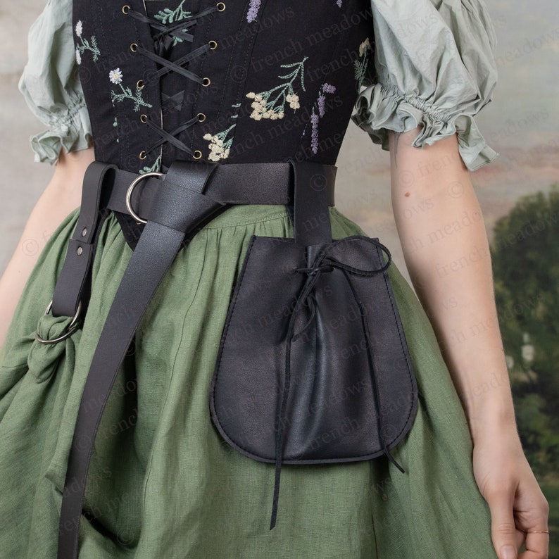 Black vegan leather drawstring pouch attached to belt, paired with floral corset and green renaissance dress