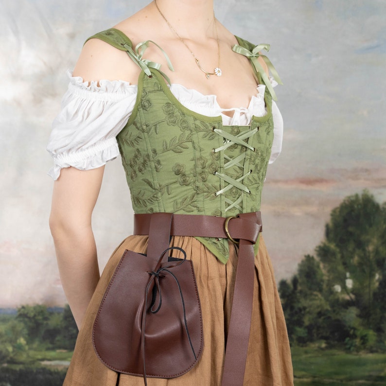 Drawstring pouch in brown vegan leather attached to belt with green renaissance costume, perfect for carrying essentials