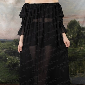 Black Chiffon Long Sleeve Chemise shown off-shoulder with flowing fabric against pastoral backdrop
