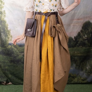 Leather Skirt Hikes shown on Renaissance dress with brown and yellow skirt, floral corset top, and leather accessories