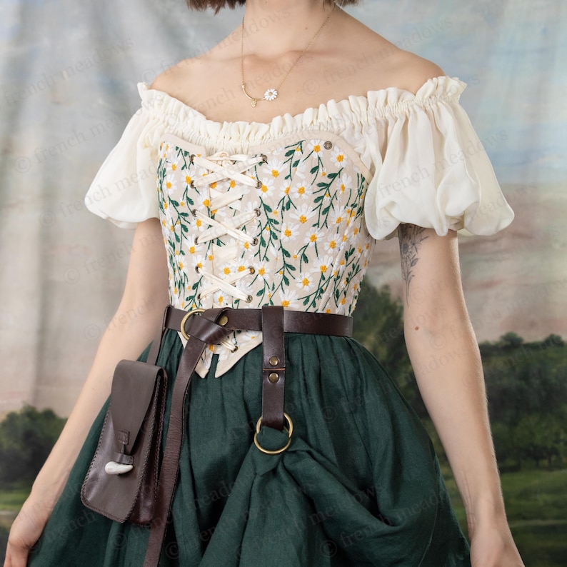 Leather skirt hikes attached to brown belt with medieval skirt in green, showing practical renaissance wear detail