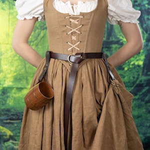 Leather Skirt Hikes shown on Renaissance dress with brown skirt, floral corset top, and leather accessories
