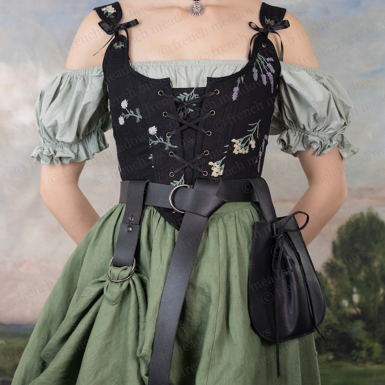 Black leather drawstring pouch attached to belt with medieval dress, perfect for renaissance faire costumes and accessories