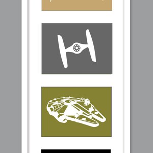 May include: A white framed print with four black and white silhouettes of Star Wars spaceships and a Death Star. The spaceships are on a tan, gray, and green background.
