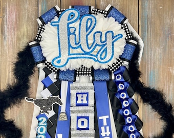 May include: A blue, black, and white graduation sash with the name "Lily" in silver glitter, the school name "Thomas High" in white, and the year "2023" in silver glitter. The sash also features a silver bell, a horse silhouette, and a blue and silver running shoe.