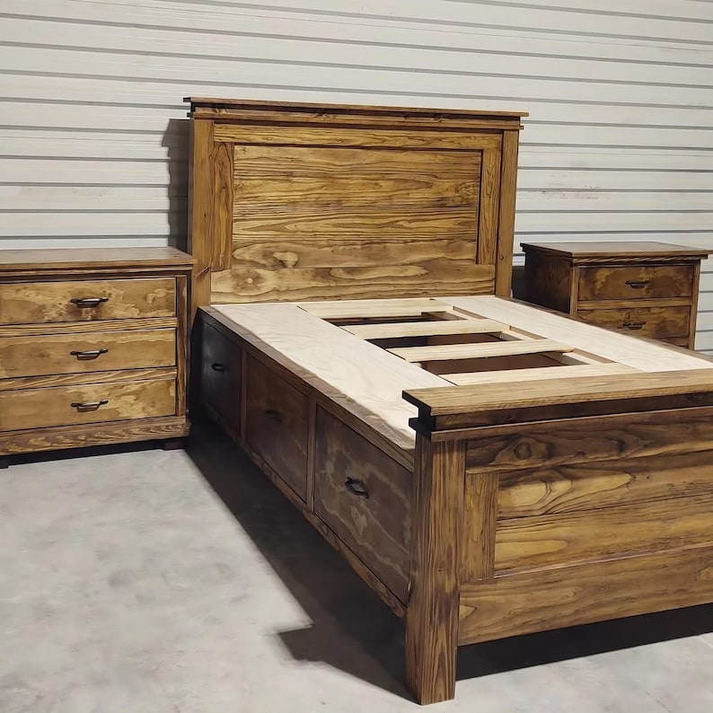May include: A wooden bedroom set featuring a bed frame with storage drawers, a headboard, and two matching nightstands. The furniture is made of stained wood with visible grain, and each nightstand has three drawers. The bed frame has a platform base.