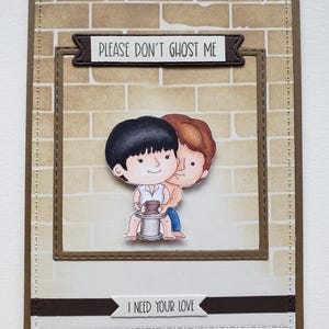 May include: A handmade greeting card with a brick wall background and two cartoon figures. The card features the text "PLEASE DON'T GHOST ME" and "I NEED YOUR LOVE". The figures are hugging each other.